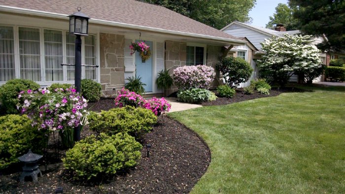 Front-yard landscape with edged flower beds, mulch and post lamp. Front-yard landscape with edged flower beds, mulch and post lamp.